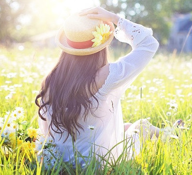 Girl sitting in field of flowers